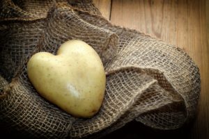 heart-shaped potato on a pile of burlap